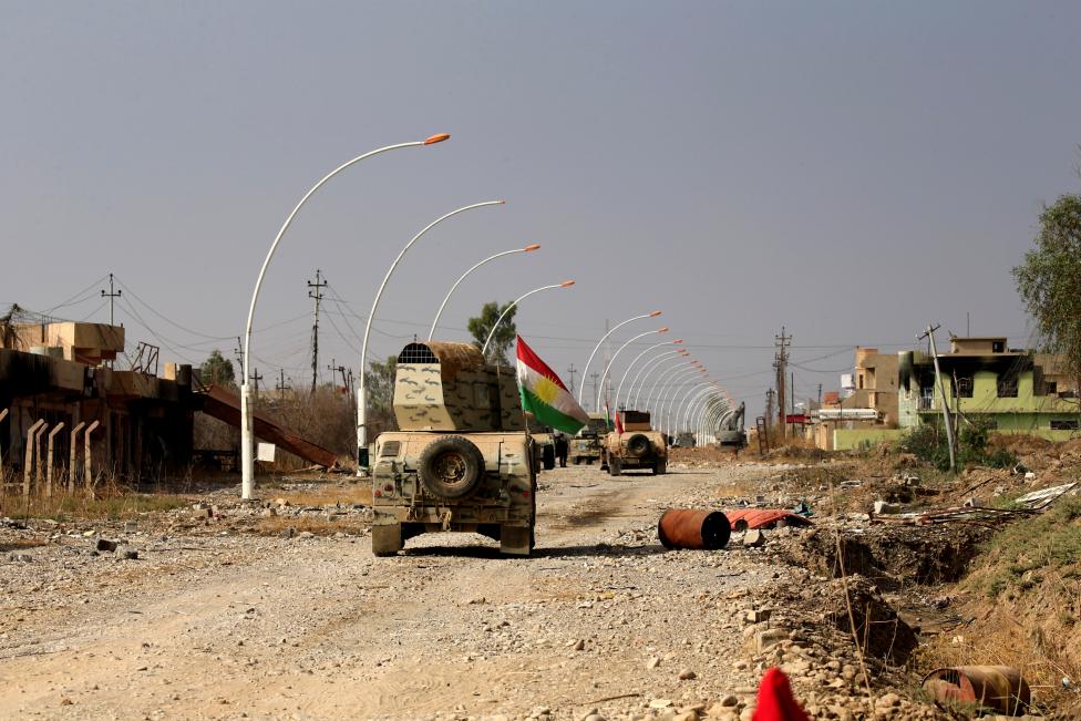 Military vehicles of Peshmerga forces drive in the town of Bashiqa, east of Mosul, during an operation to attack Islamic State militants in Mosul