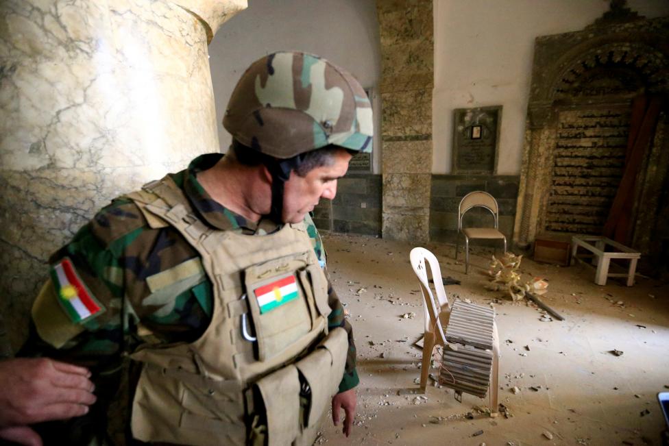 A member of Peshmerga forces inspects the Mart Shmoni Church since it was recaptured from Islamic State in the town of Bashiqa