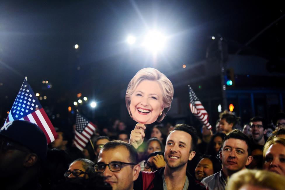 A man holds a cutout of Democratic U.S. presidential nominee Hillary Clinton in the overflow crowd outside the nominee's election night rally in New York