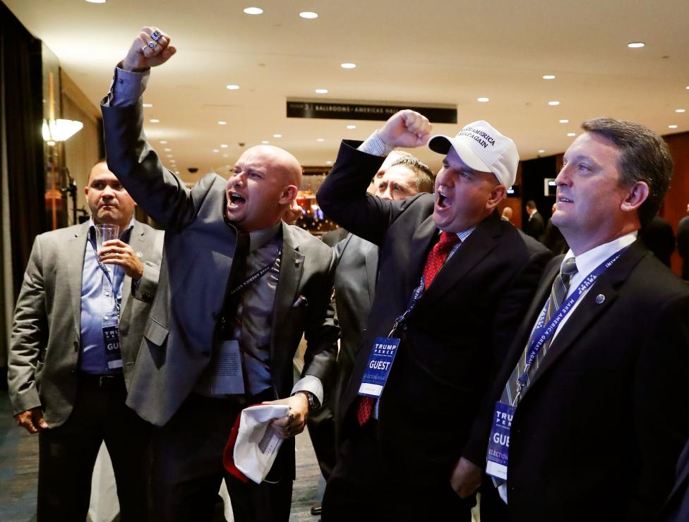 Members of the National Border Patrol Council celebrate as election results from North Carolina come in ahead of the rally for Republican U.S. presidential nominee Donald Trump in New York City