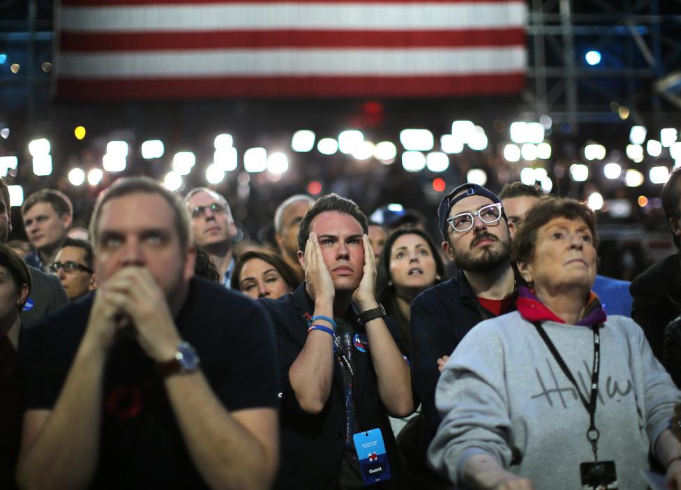 Supporters of Democratic presidential nominee Hillary Clinton watch and wait at her rally in New York