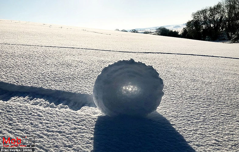 9374028 6665893 Snow rollers form when wind pushes snow across the ground gather a 84 1549295452357
